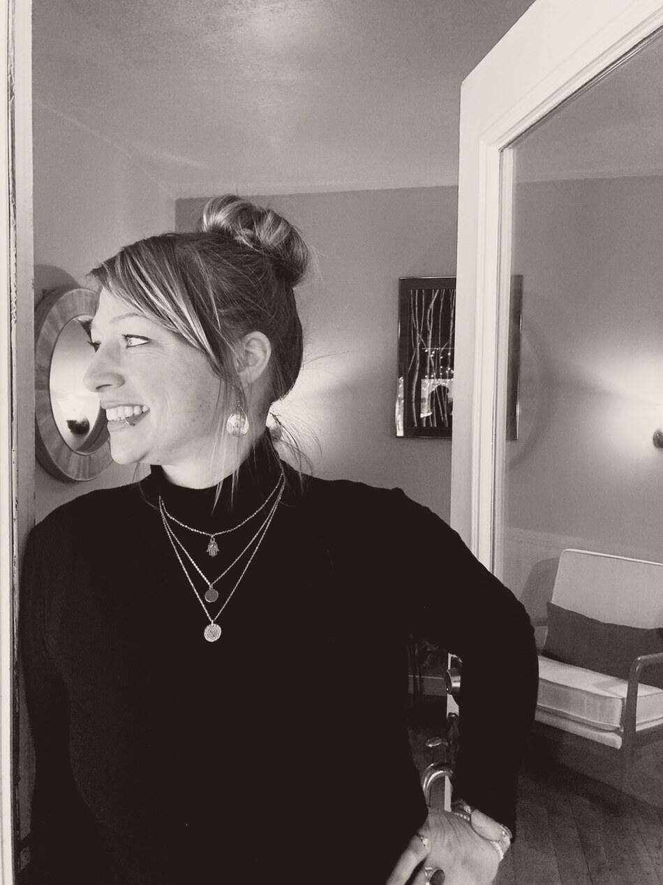 Camilla Norsworthy, founder of Awaken Reiki Studio, smiling in natural light