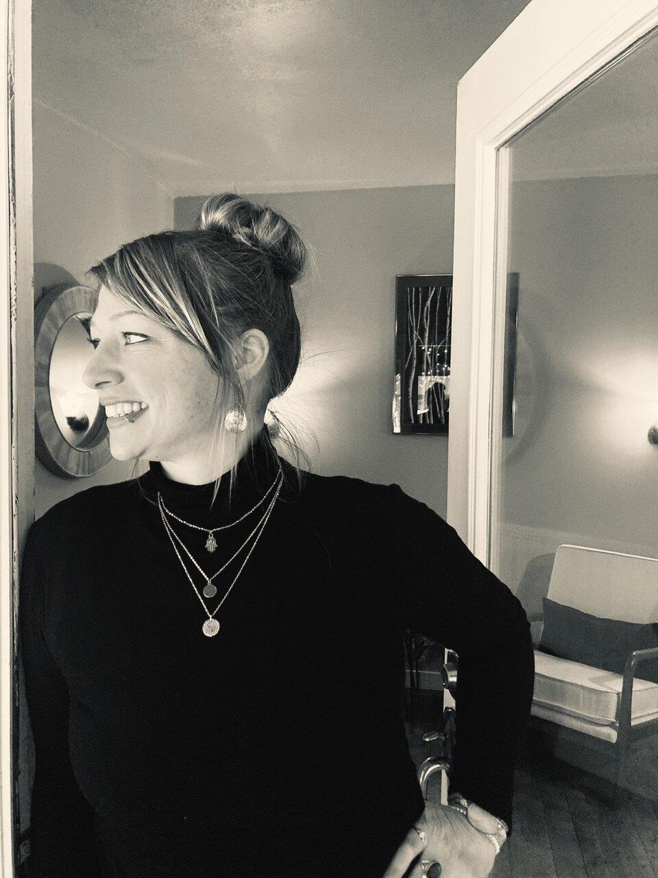 Camilla Norsworthy, founder of Awaken Reiki Studio, in a quiet moment of light at the studio